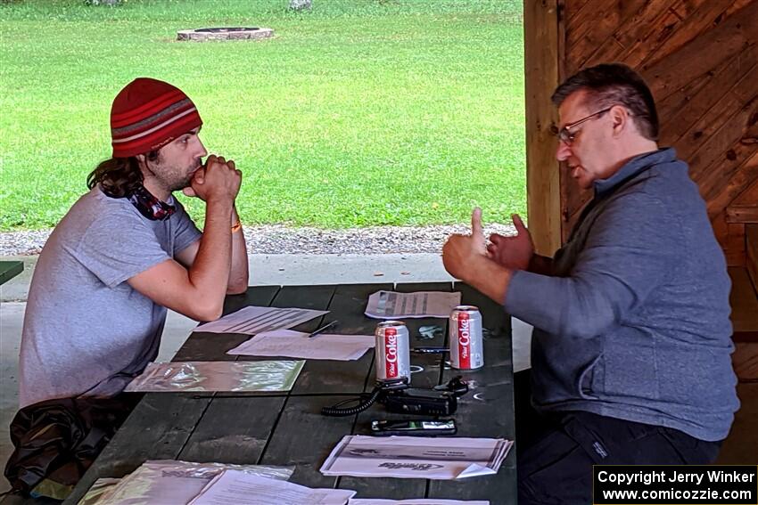 Steve Gingras discusses strategy with a new co-driver prior to the start of the rally.