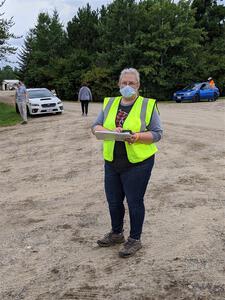 A worker dons a mask while checking cars into service.