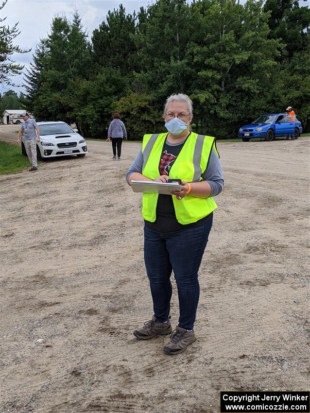 A worker dons a mask while checking cars into service.