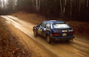 Chris Huntington / Andy Mohrlant at speed in the rain down East Steamboat Rd. in their Mazda 323GTX.