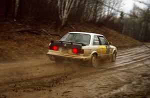 The George Hammerbeck	/ Brian Rousselow BMW 318i sprays mud through a fast sweeper. They DNF'ed the event.