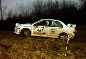 The Ron Nelson / Rick Burtis Mitsubishi Lancer Evo VII heads uphill at the crossroads hairpin spectator loaction.