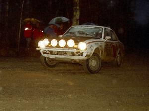 The Rob Dupree / Travis Kriza Dodge Colt slides sideways uphill through the mud at the crossroads spectator location.