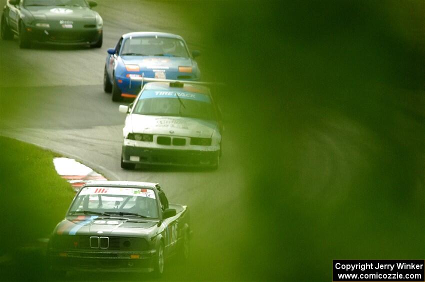Jessica Johnk's ITJ BMW 325i, Joe Bungert's ITJ BMW 318ti, Geoff Youngdahl's STL Mazda Miata and Sam Nogosek's Spec Miata Mazda