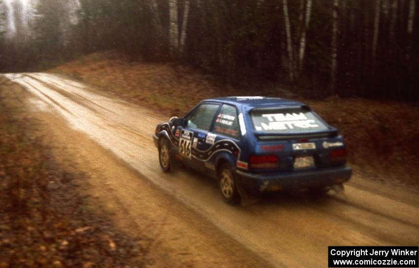 Chris Huntington / Andy Mohrlant at speed in the rain down East Steamboat Rd. in their Mazda 323GTX.