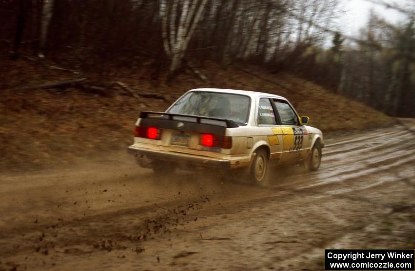 The George Hammerbeck	/ Brian Rousselow BMW 318i sprays mud through a fast sweeper. They DNF'ed the event.