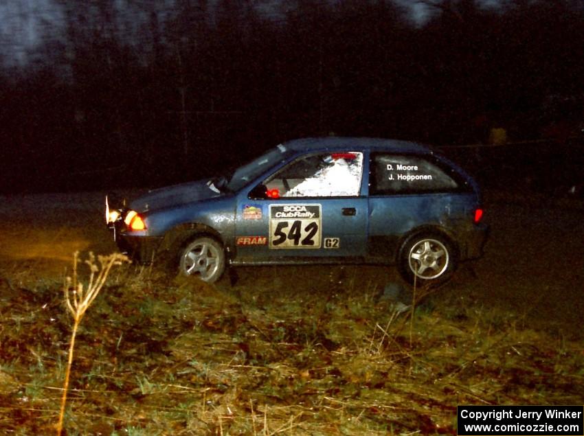 Dan Moore / John Hopponen head uphill at the crossroads spectator hairpin in their Suzuki Swift GTi.