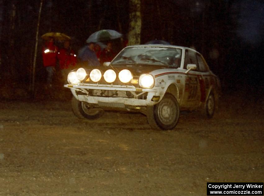 The Rob Dupree / Travis Kriza Dodge Colt slides sideways uphill through the mud at the crossroads spectator location.