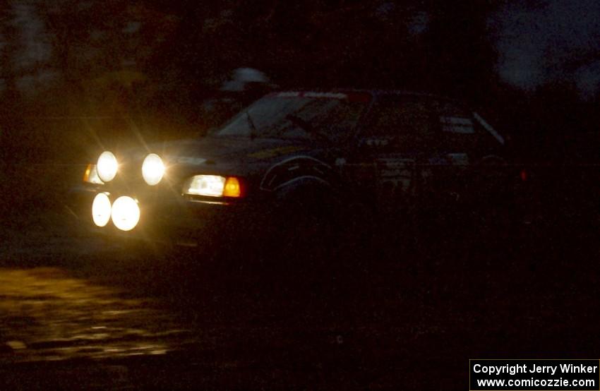 The Chris Huntington / Andy Mohrlant Mazda 323GTX heads uphill at the crossroads hairpin spectator location.