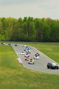 The Spec Racer Ford 3 field comes through turns 5 and 6 on the pace lap.