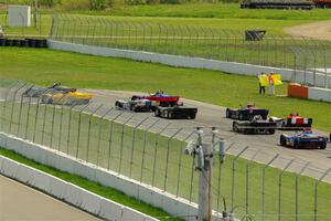 The Spec Racer Ford 3 field comes through turn 12 on the pace lap.