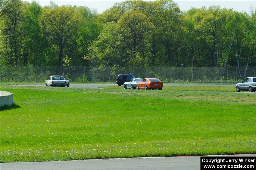 The vintage field goes through turns 4 and 5 on the pace lap.