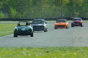 John Daniels' Sunbeam Tiger, Jessica Johnk's BMW 325i, Tim Homes' Datsun 240Z and Scott McQueen's Austin-Healey 100-6