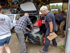 Steve McNaughton and another inspector check the Bret Hunter / Melissa Sherowski Ford Fiesta ST during tech.