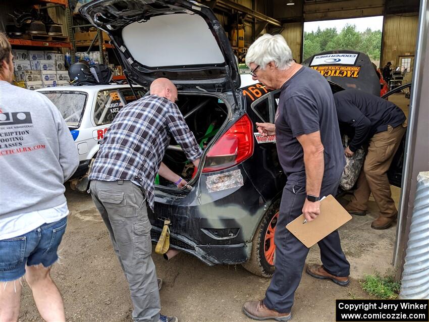 Steve McNaughton and another inspector check the Bret Hunter / Melissa Sherowski Ford Fiesta ST during tech.