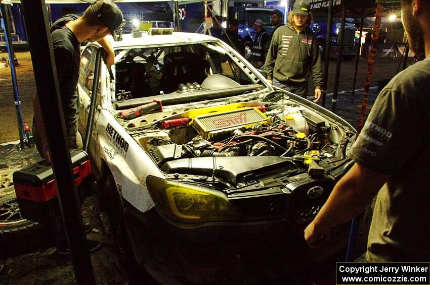 Dave Carapetyan / Adam Kneipp Subaru WRX STi gets some repairs after day one on the stages.