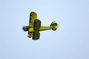 A Stearman biplane flies overhead along the route.