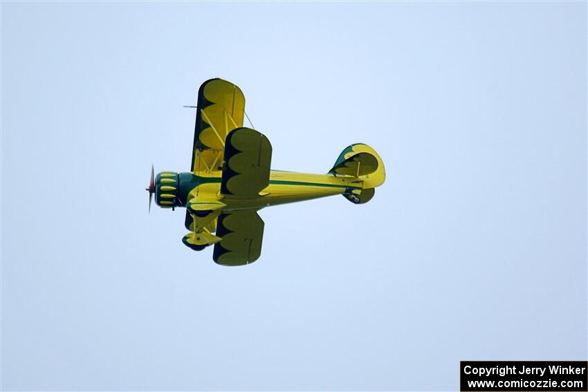 A Stearman biplane flies overhead along the route.