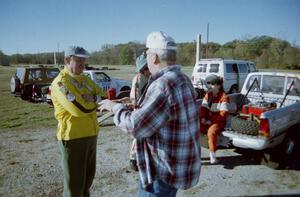 Mike Halley and Bruce Weinman chat before the start of the event as Emily Burton-Weinman takes a breather.