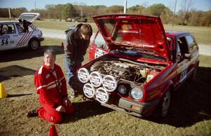 J.B. Niday has a smoke and worships the rally gods as Will MacDonald looks in awe at the motor.