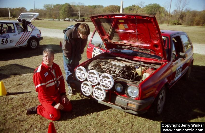 J.B. Niday has a smoke and worships the rally gods as Will MacDonald looks in awe at the motor.