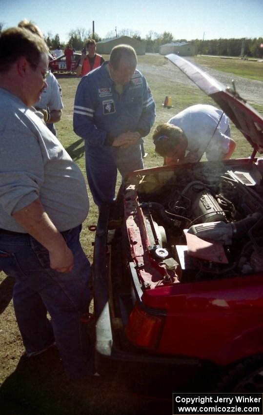 Smoke pours from the Mark Utecht / Kristi Anderson Dodge Omni GLH at service.