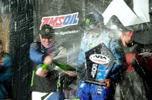 Paul Rowley and Ken Block spray each other on the winners' podium.