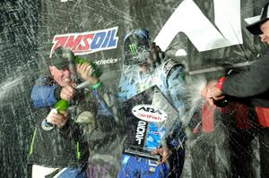 Paul Rowley and Ken Block spray each other on the winners' podium.
