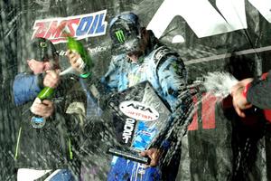 Paul Rowley and Ken Block spray each other on the winners' podium.