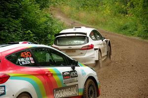 Allen Dobasu / Patrick Walsh Ford Fiesta passes the Lucy Block / Michelle Miller Ford Fiesta Rally3 on SS1, Crossroads I.