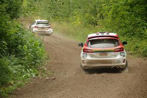 Allen Dobasu / Patrick Walsh Ford Fiesta passes the Lucy Block / Michelle Miller Ford Fiesta Rally3 on SS1, Crossroads I.