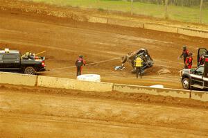 Robin Shute's Can-Am Maverick X3 is flipped back over by the safety team.