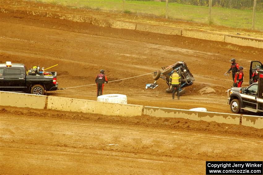 Robin Shute's Can-Am Maverick X3 is flipped back over by the safety team.