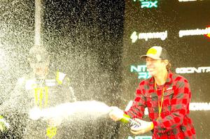 Travis Pastrana and Brian Deegan spray the crowd at victory lane.