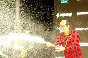 Travis Pastrana and Brian Deegan spray the crowd at victory lane.