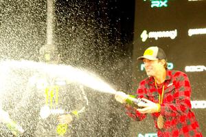 Travis Pastrana and Brian Deegan spray the crowd at victory lane.