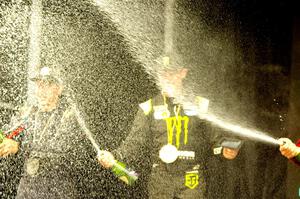 Travis Pastrana and Brian Deegan spray the crowd at victory lane.