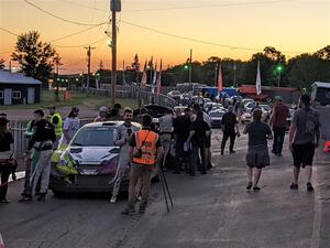 Patrick Gruszka (/ Florian Barral) is interviewed in front of his Mitsubishi Mirage RS after the event.