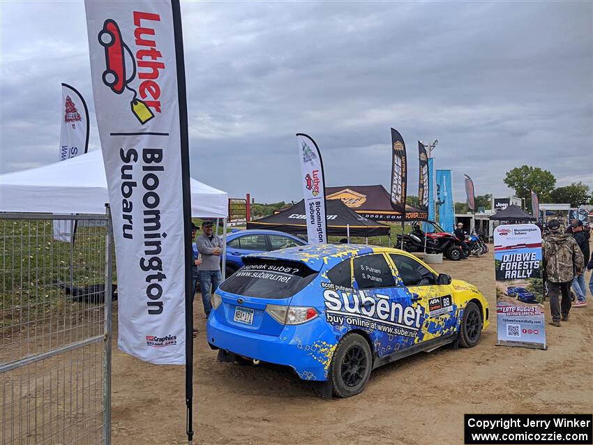 Scott Putnam's Subaru WRX STi rally car on display.
