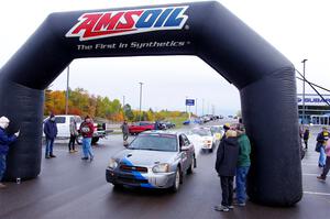 Andrew Dustman / Rachel Dustman Subaru Impreza leaves the ceremonial start.