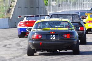 Dan Little's American Sedan Ford Mustang and Dan Corgard's Spec Miata Mazda Miata head for the track exit.