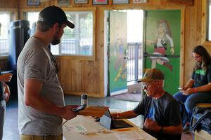 Eric Linner checks in workers at registration.