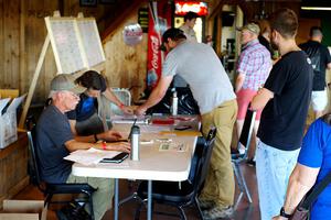 Eric Linner checks in workers at registration.