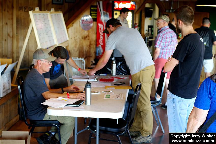 Eric Linner checks in workers at registration.