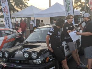 John Farrow and Michael Farrow are interviewed in front of their Subaru WRX at Thursday evening's parc expose.