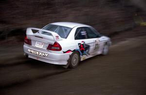 Brian Scott / David Watts drift through a sweeper on SS1 in their Mitsubishi Lancer Evo IV.