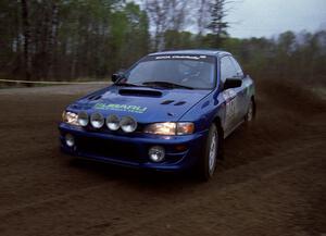 Kazimierz Pudelek / Mark Pudoluch drift through a 90-left on SS2 in their Subaru Impreza.