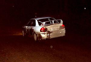 Brian Scott / David Watts at speed at night in their Mitsubishi Lancer Evo IV.