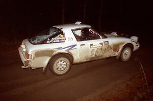 Bob Cutler / John Atsma drift their Mazda RX-7 through a fast sweeper at night.
