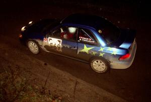 Kazimierz Pudelek / Mark Pudoluch drift through a fast sweeper at night in their Subaru Impreza.